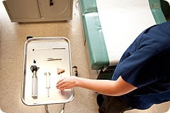 Medical Assisting student reaching for an instrument.