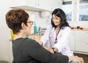 Phlebotomist Smiling Near Patient Phlebotomist Smiling Near Patient