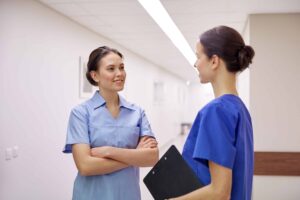 Two Nurses in Hallway Two Nurses in Hallway