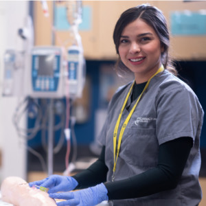 Carrington College medical student in medical office smiling