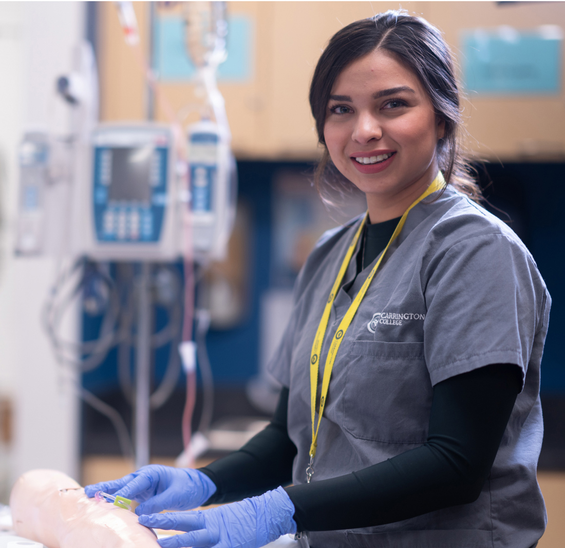 Carrington College medical student in medical office smiling