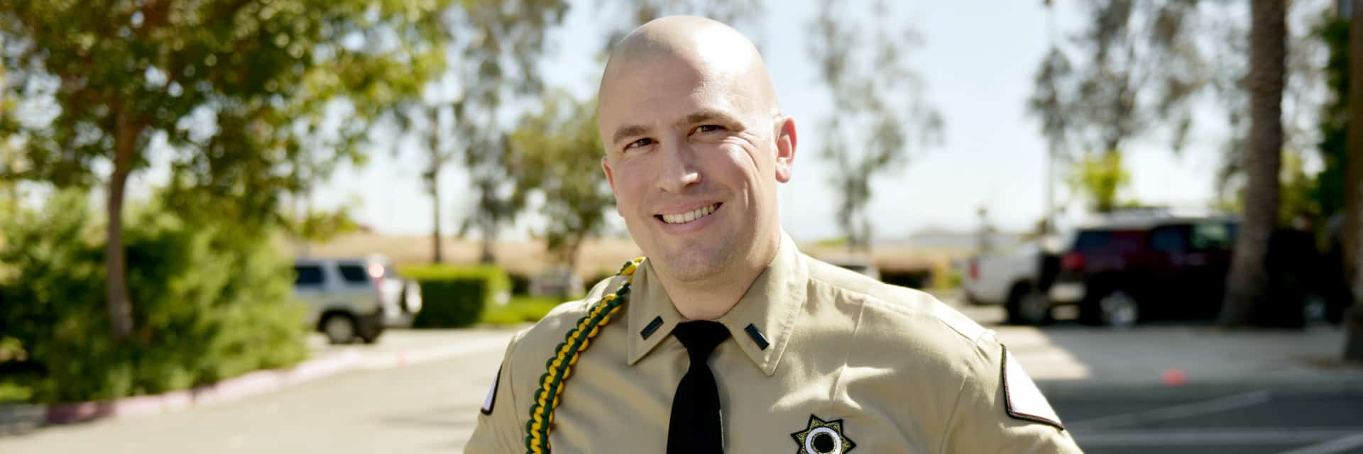 Man in tan security uniform.
