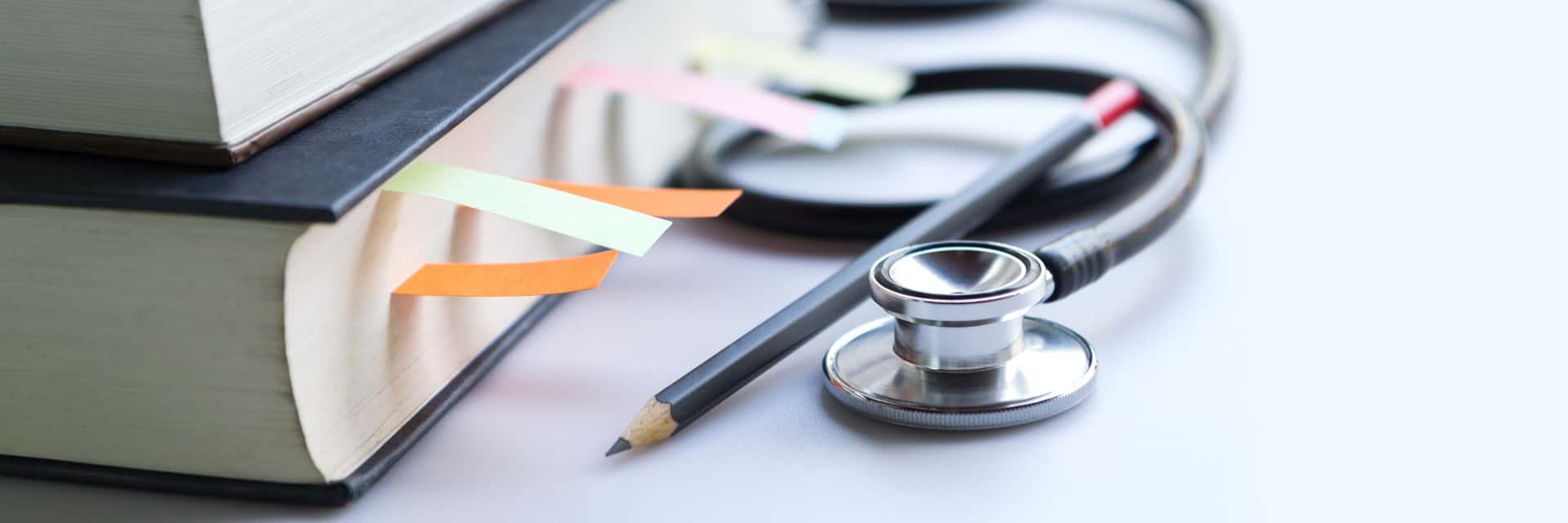 Books, a stethoscope, and a pencil.