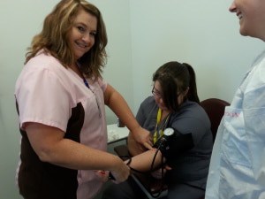 Tucson MA Instructor Ms. Judy taking blood pressure