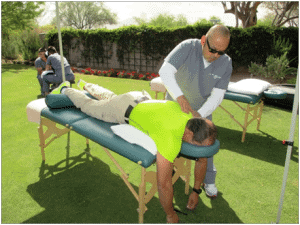 Carrington student giving massage at Delta Dental Golf Tournament