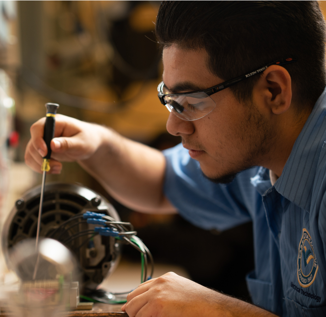 Carrington College trade student working on a mechanism