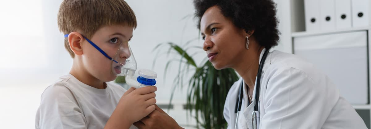Respiratory Therapist giving breathing treatment to young patient