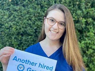 carrington san jose 2020 graduate holding image of another hired grad sign