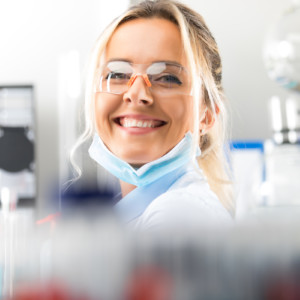 Happy young attractive smiling woman scientist in the laboratory