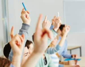 Group of Students Raising Hands