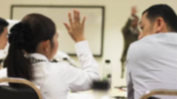 Student Raising Hand in Classroom