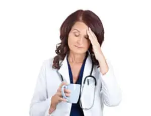 Tired Nurse Holding a Cup Tired Nurse Holding a Cup