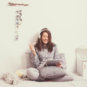 Woman with Tablet Wearing Headphones